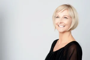 Woman smiling confidently after Botox treatment.